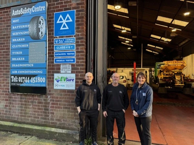 BookMyGarage employee stood outside AutoSafetyCentre Haydock with the garage owners